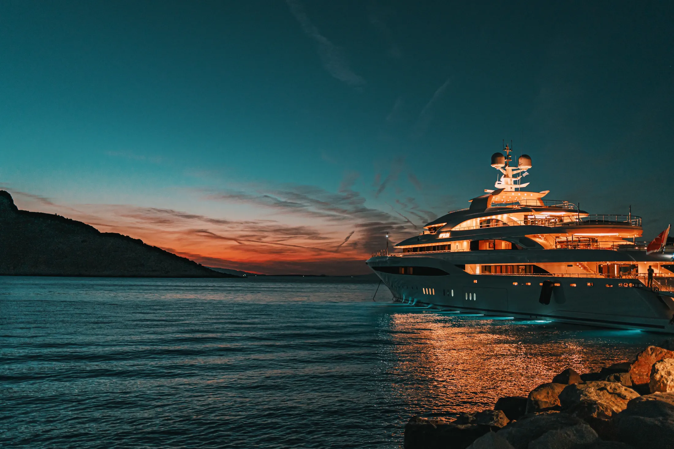 Luxury yacht at anchor during sunset